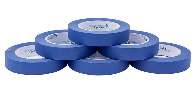 Six rolls of blue painter’s tape are neatly stacked in a pyramid shape.