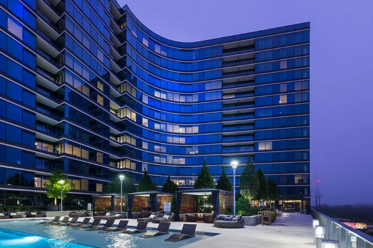 Poolside view from the sixth floor of the Hanover Buckhead Village luxury apartment building in Atlanta, GA, at dusk.