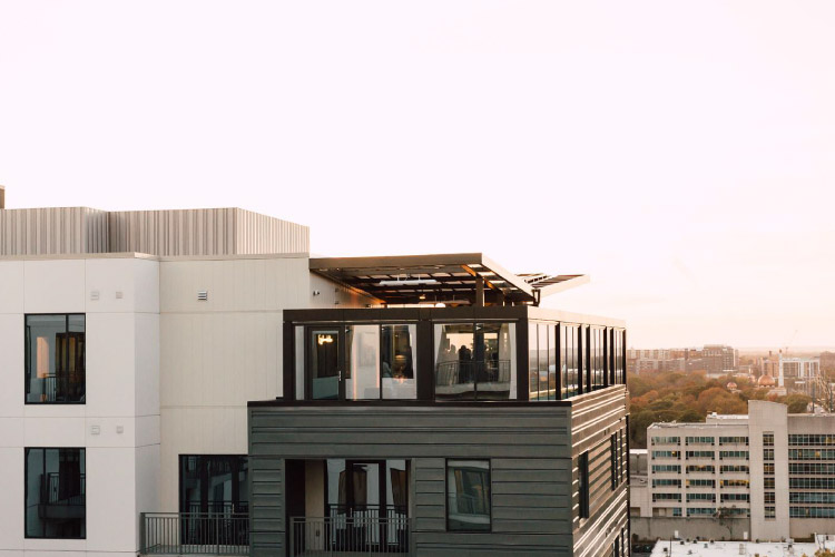 View of the higher levels of the Novel Midtown apartment building in Atlanta, Georgia. The building features a modern yet simple design and looks out over Midtown Atlanta.