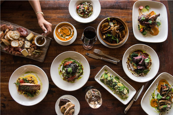 Top-view of an impressive display of appetizers, entrees, soups, and salads, at Taverna San Marco in Jacksonville, Florida.