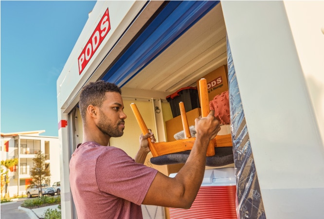 A man is loading his PODS portable moving container for his move out of Los Angeles.