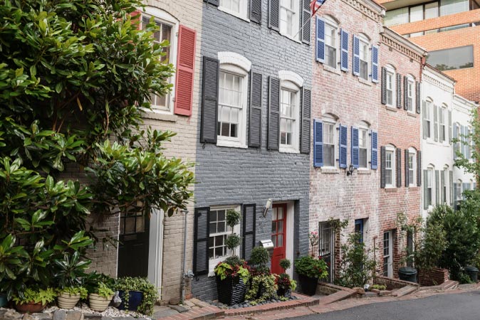 A downhill, street view of old townhouses in Georgetown, Washington, D.C.