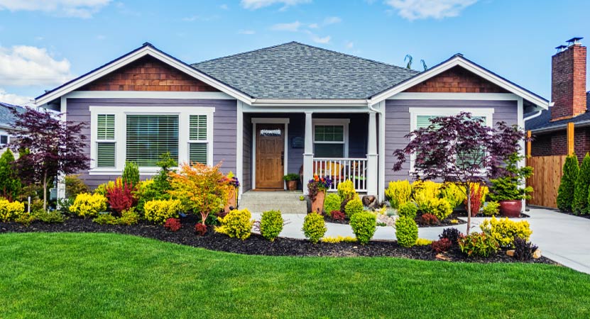 a home with a front yard that has been nicely landscaped for the summer