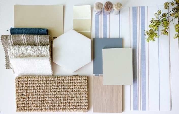 A blue, white, and brown mood board of assorted bedroom items including sheets, linens, and textures.