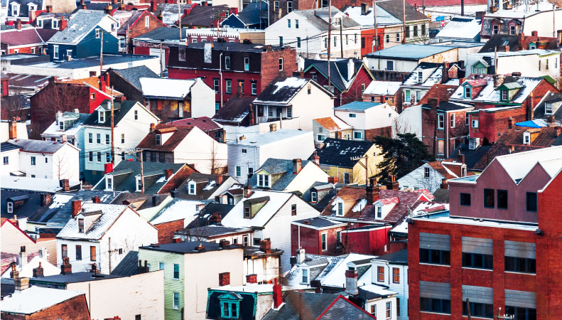 A birds-eye view of a densely populated neighborhood in Pittsburgh, PA. All you can see are row after row of houses, rowhomes, condominiums, etc.