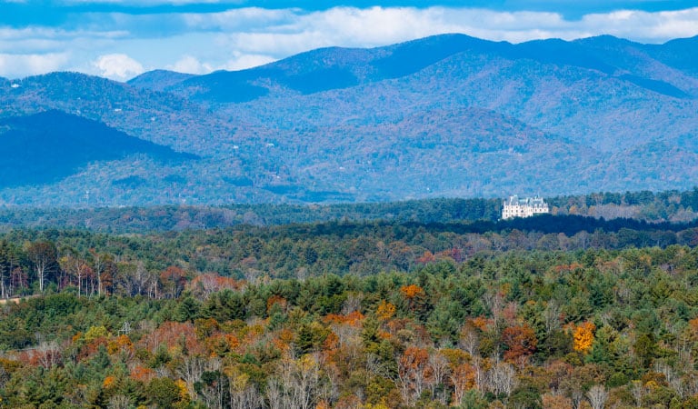 A view of the Biltmore House in front of the mountains