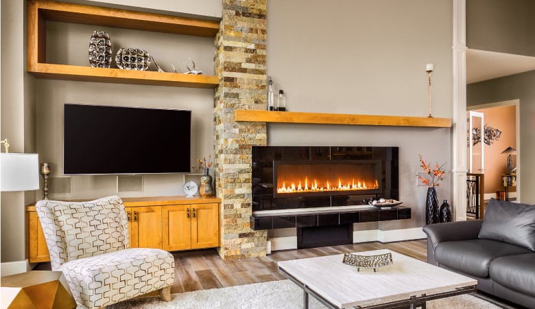 A wide-open living room with a stylish, simple gas fireplace