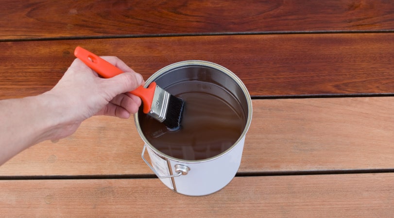 someone re-staining their wood deck