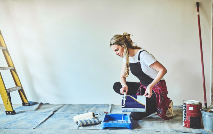 A woman painting her home