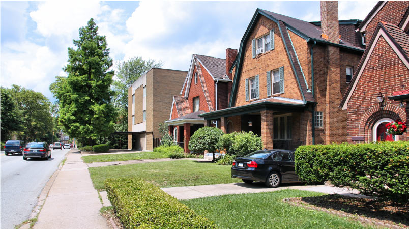 A sidewalk view of four homes in the Shadyside district in Pittsburgh, PA