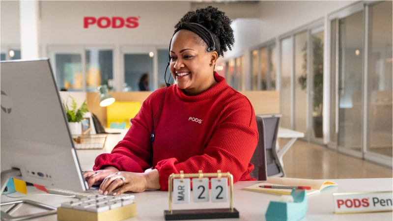 a PODS customer service representative helping a customer on the phone