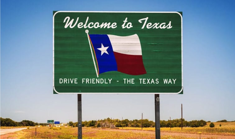 A highway sign reading, Welcome to Texas, "Drive Friendly - The Texas Way"