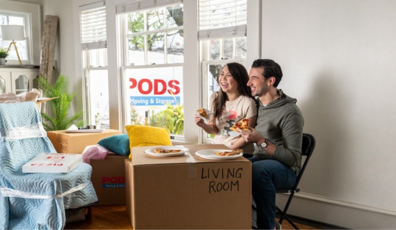 A couple enjoys pizza while they prepare for their move to Columbus, OH.