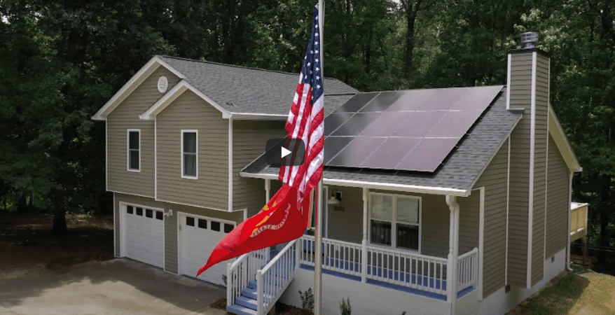 A newly renovated home belonging to a U.S. veteran. There is a flag pole outside with an American flag. 