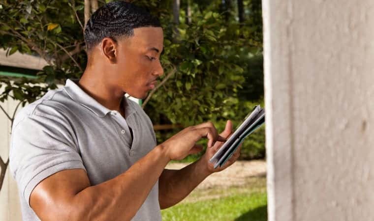 Man assessing damage to house