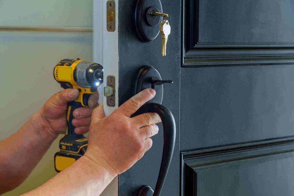 locksmith adjusting the locks on a door