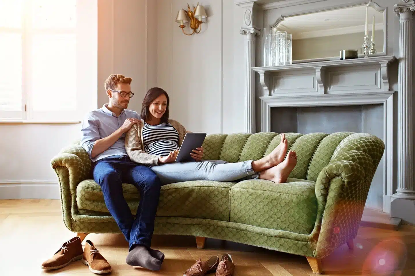 couple sitting on couch with computer