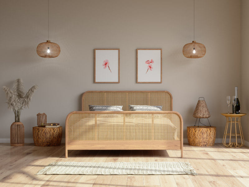 A bedroom that has been arranged according to feng shui. There is symmetry in the placement of furniture and hanging lamps, natural light is streaming in from a window, and the wicker bed is positioned for optimal comfort. 