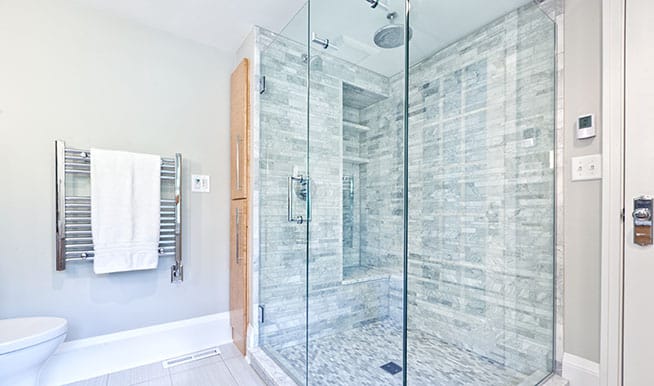 A blue-and-white walk-in shower that takes inspiration from spa designs. 
