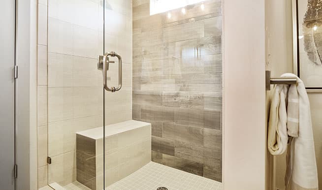 A walk-in shower with a stylish bench to make it more easily accessible. 