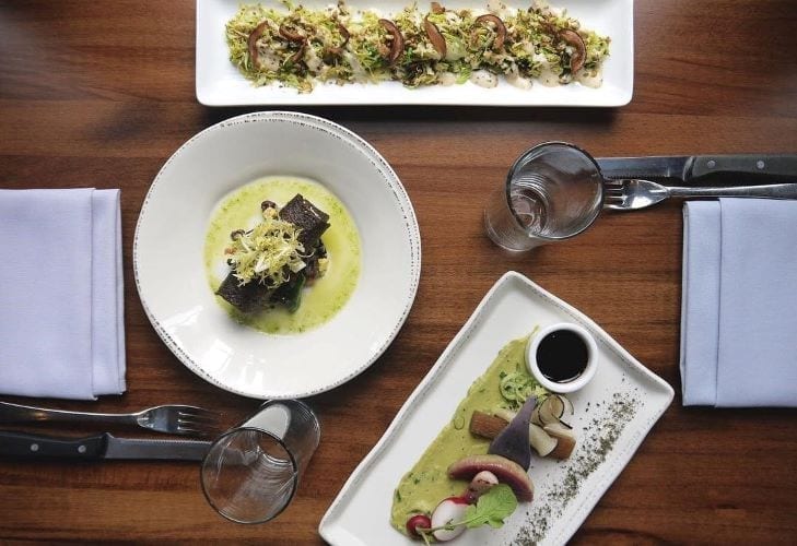 A top-view of three entrees from Vedge, a vegetarian restaurant in Philadelphia.