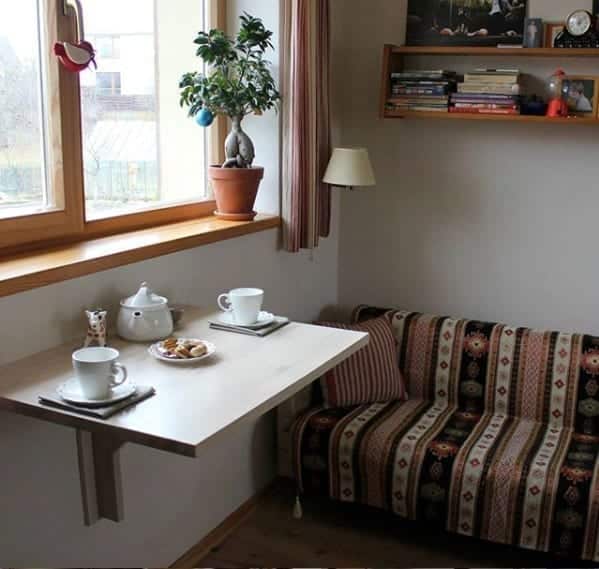 IKEA’s BJURSTA wall-mounted drop-leaf table installed in the dining space of a city apartment.