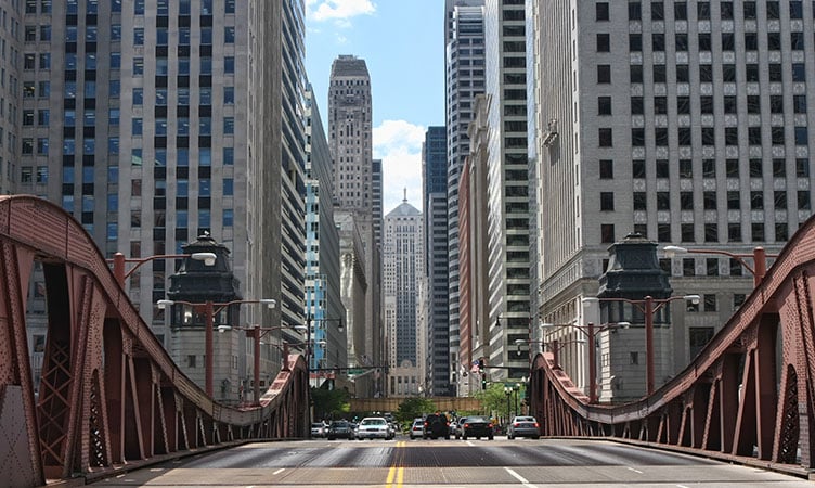 The scene from the car as you move to Chicago: A view straight down the road between towering skyscrapers.