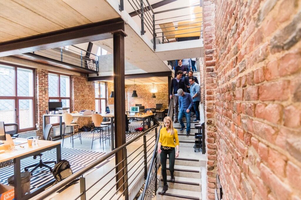 Employees walking down a staircase in a stylish office buiding