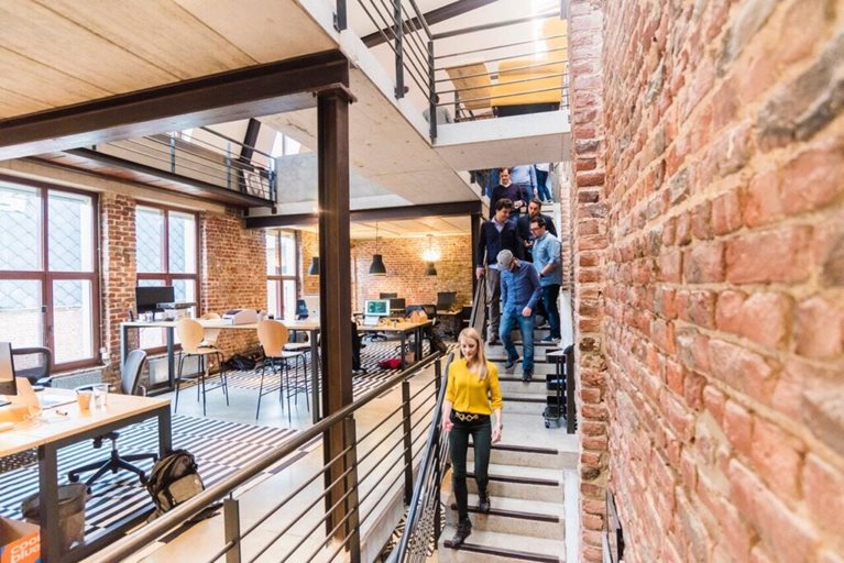A team of associates walking down a flight of stairs