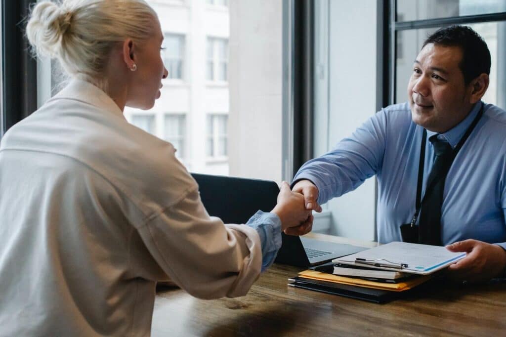 An image of a man and woman shaking hands.