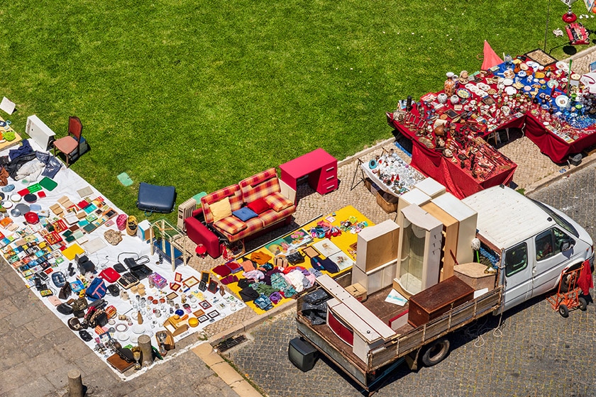 Tables floor displays of goods at an outdoor flea market