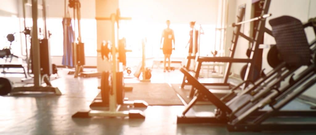 People exercising inside a gym in the evening