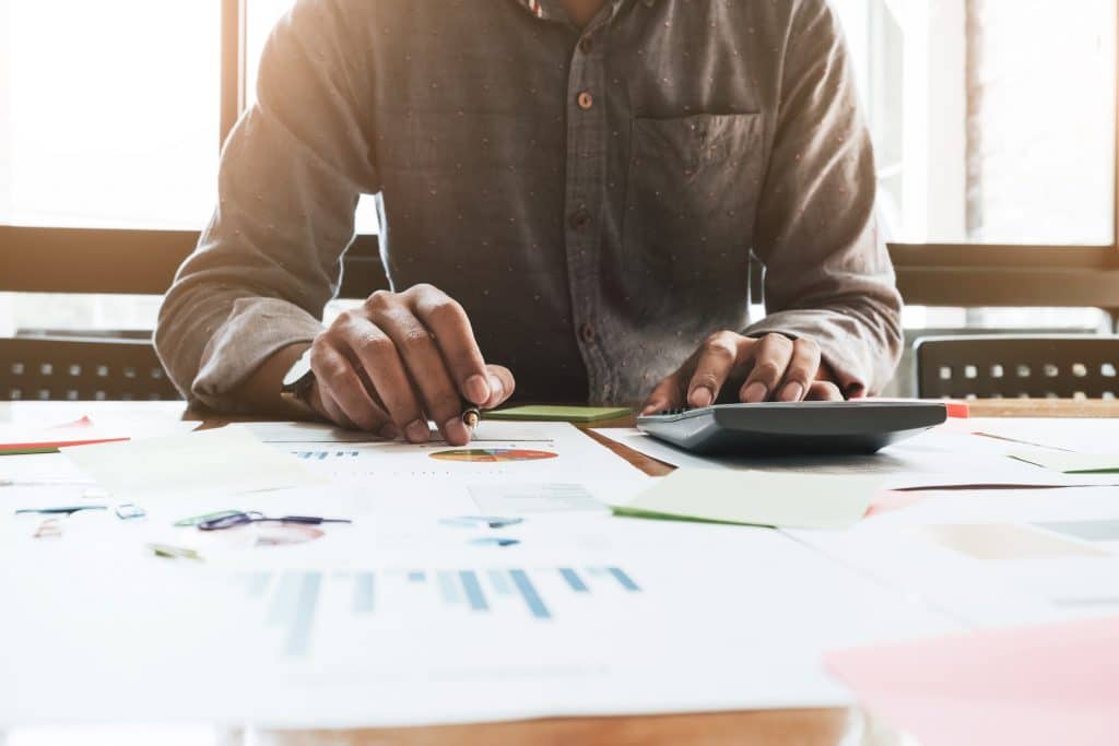 Small business owner reviewing revenue paperwork