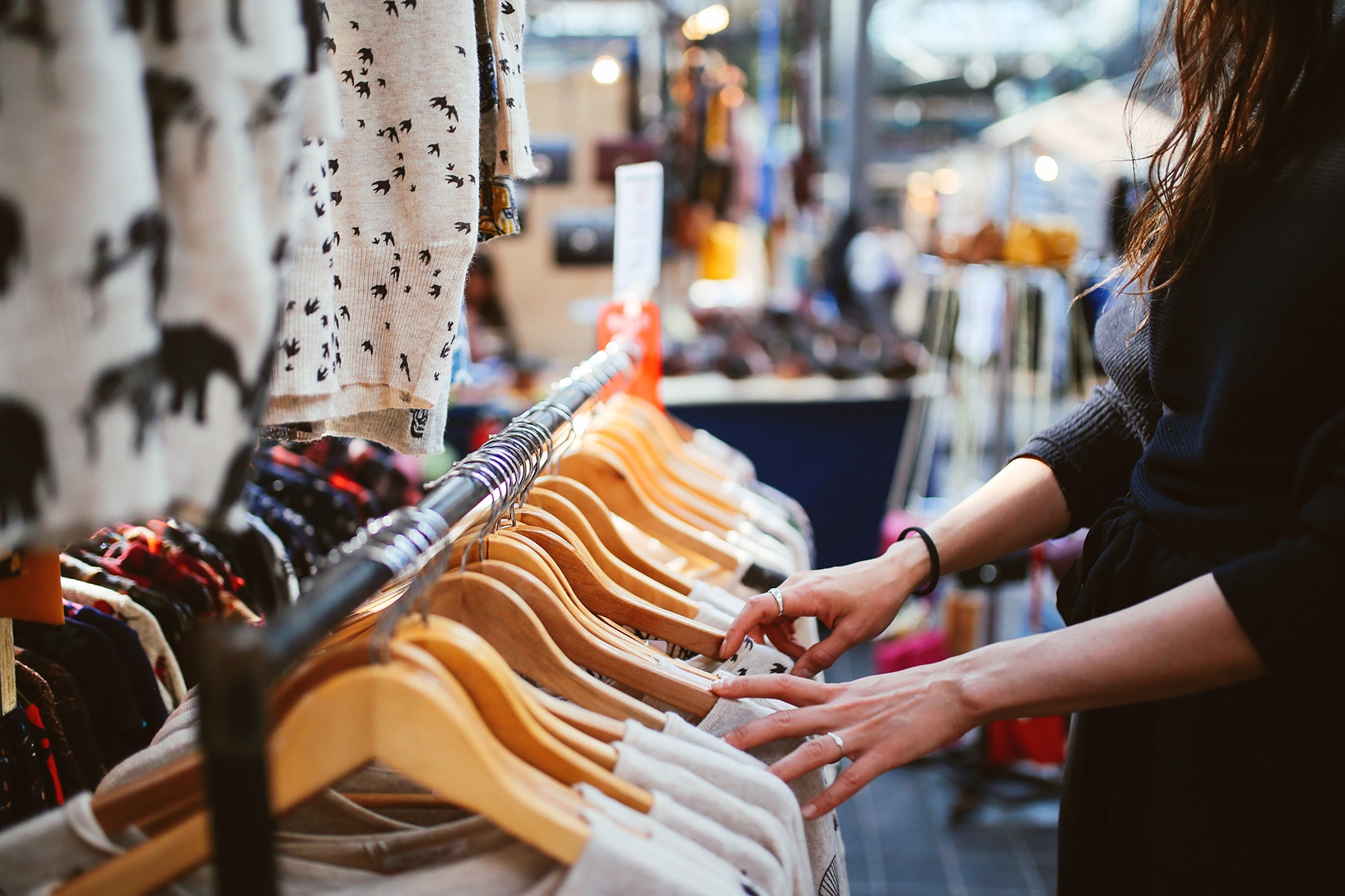 Women looking at clothing at an e-tailer pop-up shop