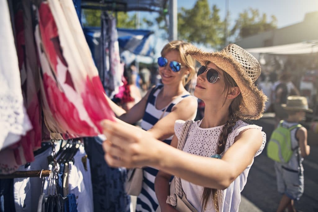 Shoppers looking at clothes at a flea market