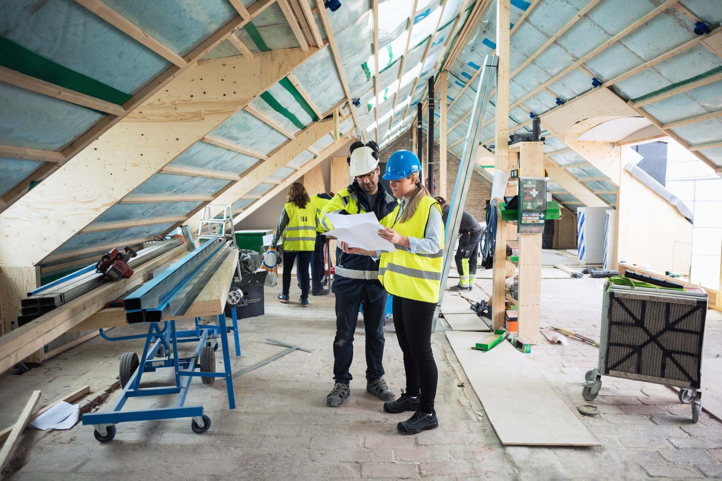 Two construction workers reviewing plans