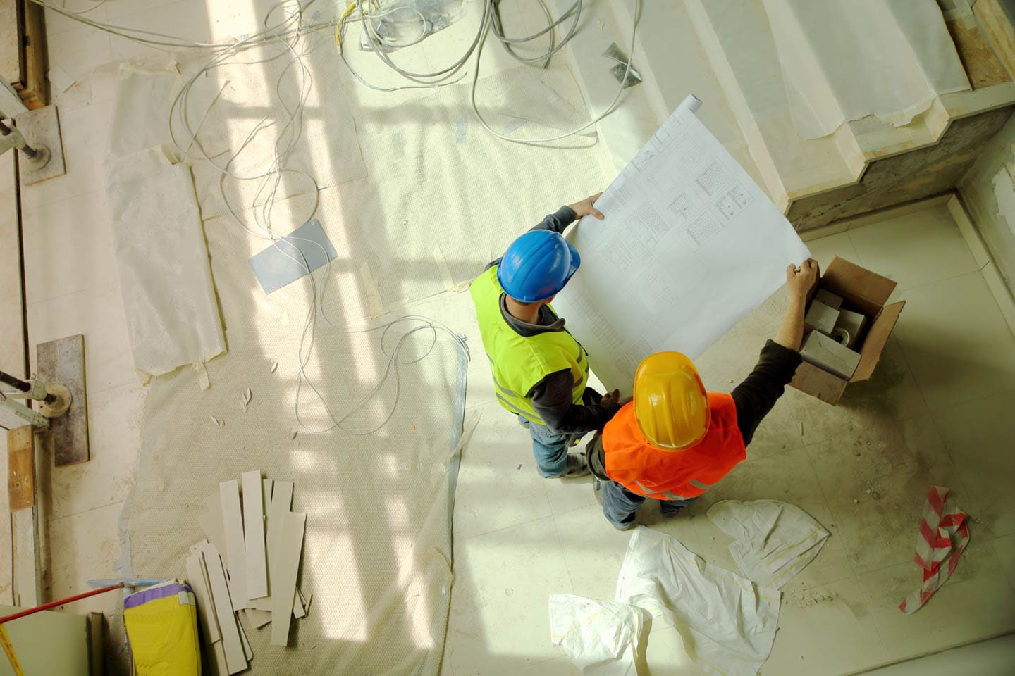 Construction team reviewing blue print plans