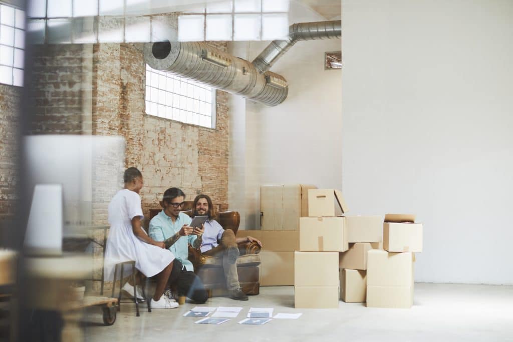 Team inside an office making plans for a business move to Atlanta