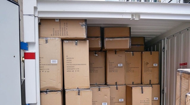 A photo of a PODS container filled with boxes of event supplies