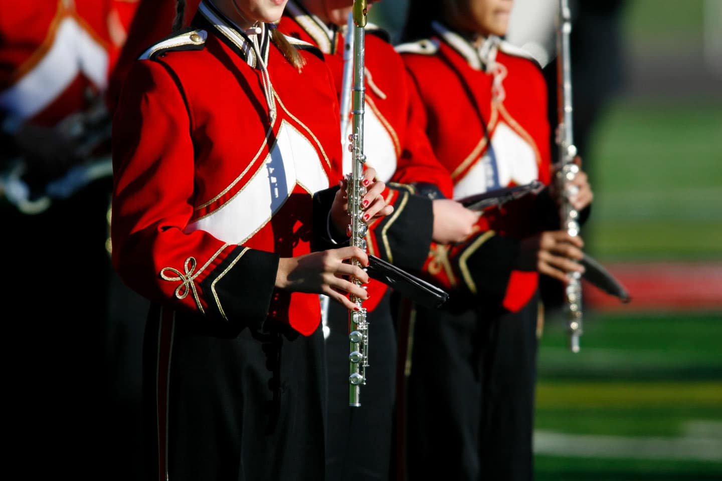 Members of a high school marching band holding instruments