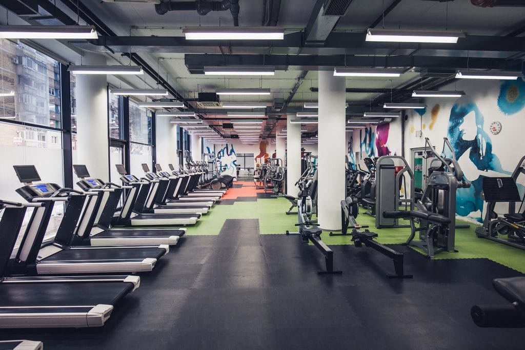 An empty gym with exercise machines that can support corporate wellness