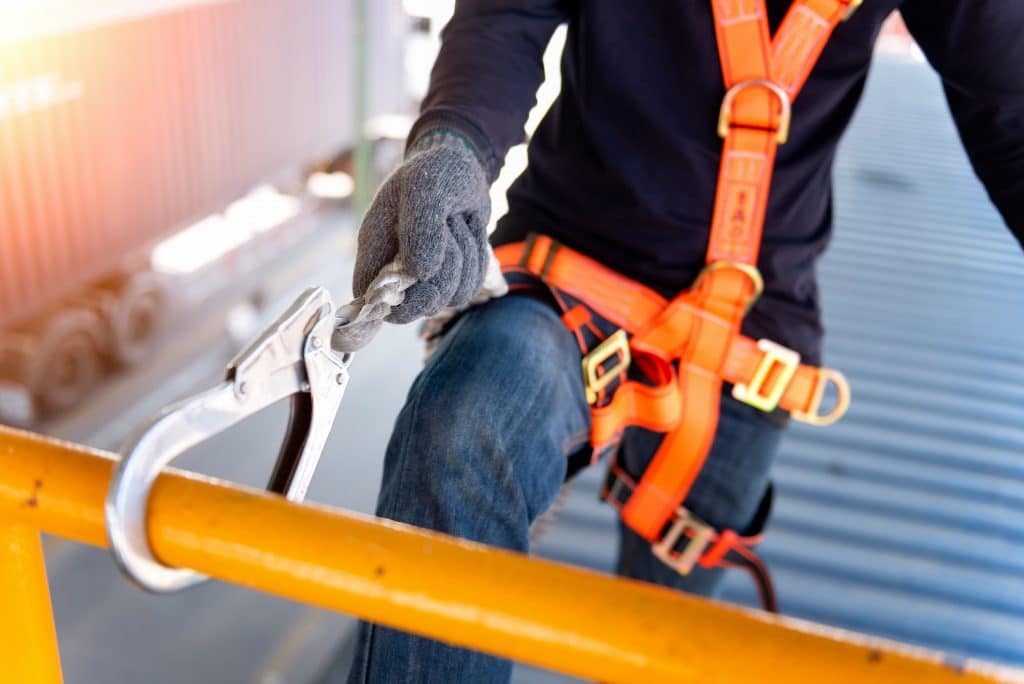 A construction using a safety harness on a scaffold to improve TRIR safety