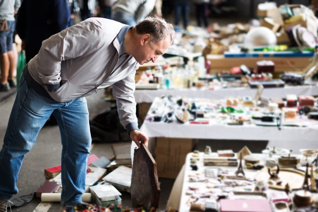 Man browsing items in an antique market