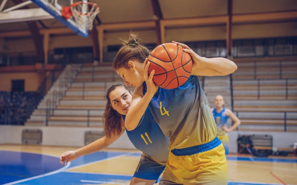 Two female college basketball players