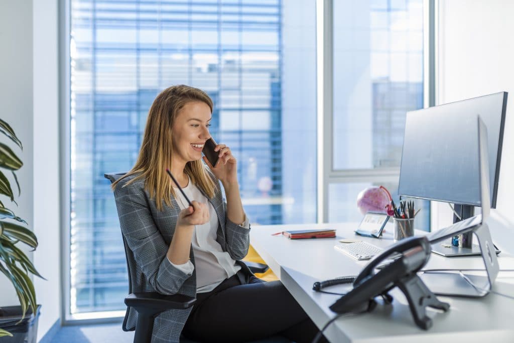 Female business owner talking on the phone at desk