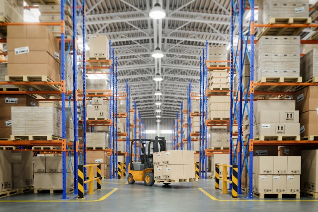 Forklift moving crates of inventory inside a warehouse