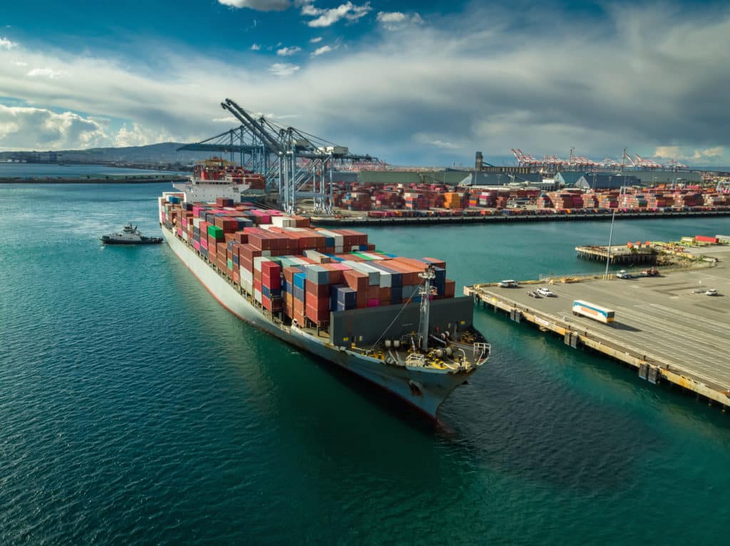 Cargo ship with shipping containers arriving to Los Angeles