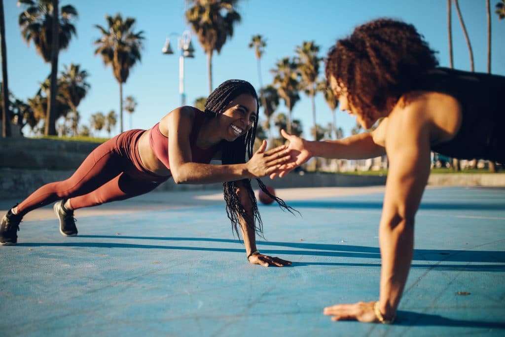 Two women in a group fitness class representing millennial spending habits