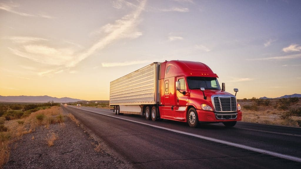 A rental truck on a highway in the desert carry cargo for a business move