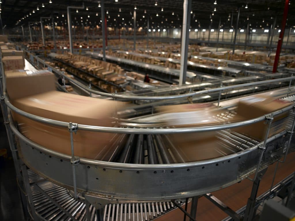 Boxes moving on a belt inside a fulfillment center for inventory management